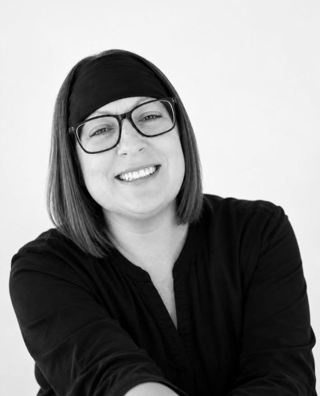 Hillary Scott of The Hillary, smiling, wearing glasses and a black headband
